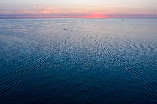 Single boat on Lake Michigan watching the sunset