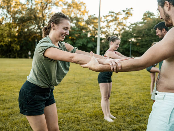 istock People practising Acro Yoga in the park 1341918227