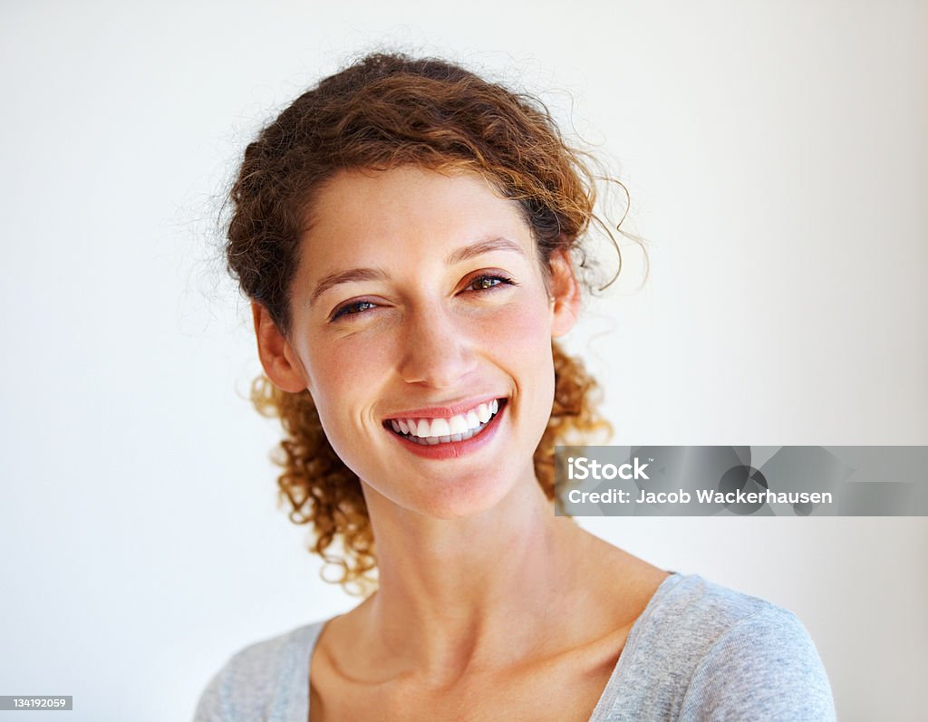 Her perfect smile Portrait of lovely Caucasian woman smiling over a plain background Women Stock Photo