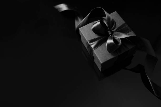 istock Black Friday template with a black gift box on a dark background. 1341922649