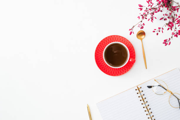 istock Flat lay composition with cup of coffee, branches with red berries and notebook on a white background 1341922725