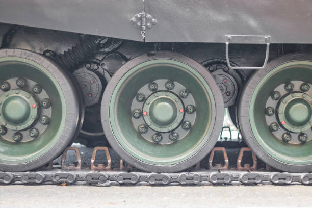 istock Caterpillar tracks and rollers of military equipment 1341923444