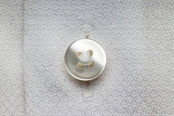 istock White button on a white men's shirt, close-up 1341923488