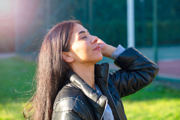 istock Beautiful woman having fun at park 1341925523
