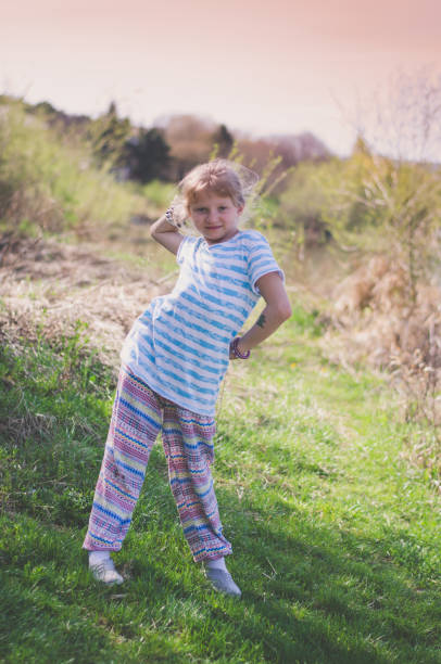 istock cute girl posing in green meadow 1341925610
