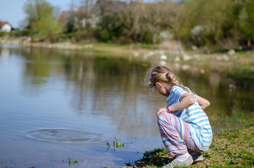 adorable cute child relaxing by the water