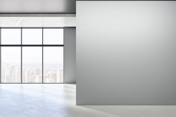 istock Modern empty concrete room interior with blank mock up place on wall, windows, city view, sunlight and shadows. 3D Rendering. 1341925820