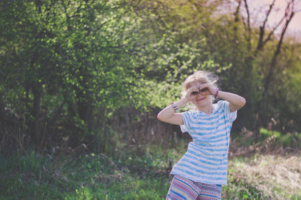 istock cute girl posing in green meadow 1341925940