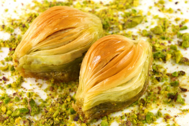 istock Turkish Midye Baklava  ( Mussel Shape Baklava ) with green pistachio nuts. 1341926030