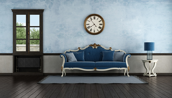 Blue classic sofa in a old room with old radiator under wooden windows - 3d rendering\nNote: the room does not exist in reality, Property model is not necessary