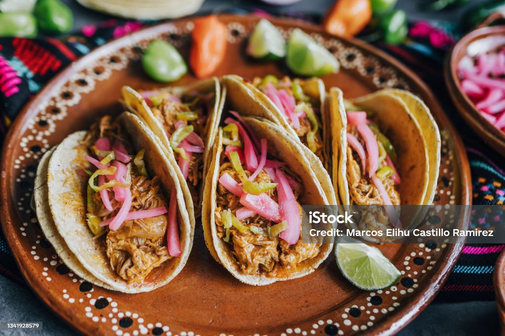 mexican tacos flat lay composition with pork carnitas, cochinita pibil, onion and habanero chili traditional food in Mexico Taco Stock Photo