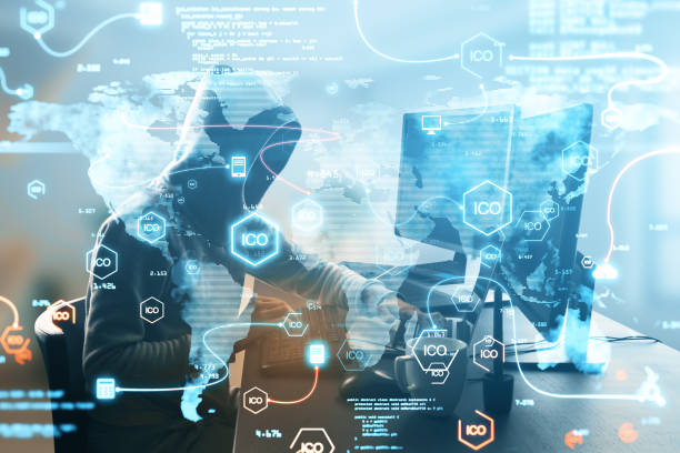 istock Hacker at desktop using computer with creative glowing ico hologram with icons and map on blurry background. Initial coin offering, malware and cryptocurrency concept. Double exposure. 1341928942