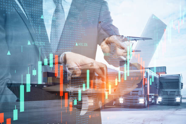 istock Businessmen with laptop standing on abstract double exposure background with forex graph, cargo airplane, truck and ship. Teamwork, business, shipping, trade and logistics concept. 1341928961