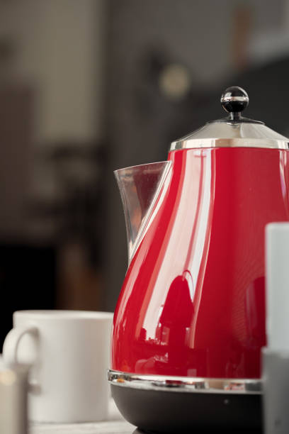 istock Vintage style red electrical teapot in kitchen interior 1341929733