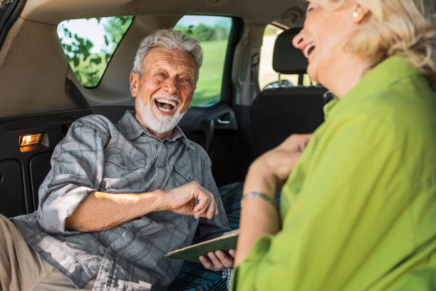 istock Senior couple in nature reading book having fun 1341930363