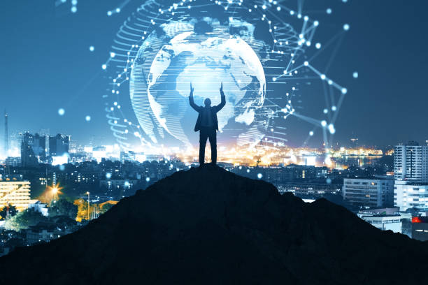 istock Businessman on backlit hill holding abstract polygon globe hologram on illuminated night city background. Polygonal network, science, communication, programming and earth concept. 1341933366