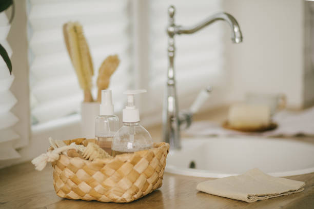 istock Kitchen interior with natural eco-friendly zero waste cleaning items: brushes, rugs, soap, spray and sponges in a wicker basket. 1341933384