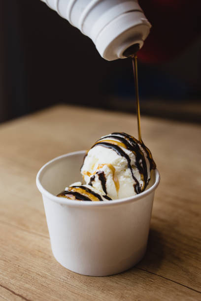 istock caramel topping in a thin thick stream on balls of ice cream 1341934189