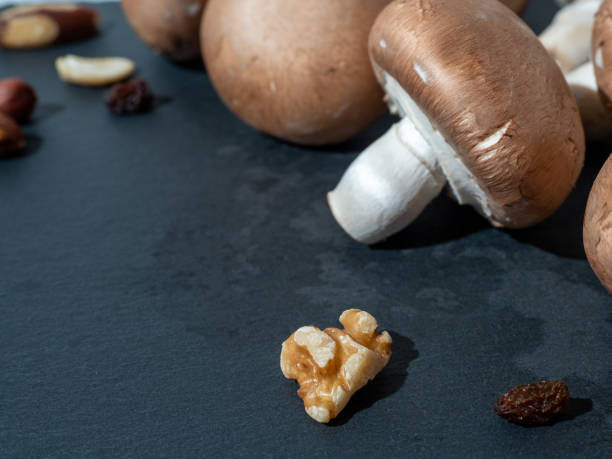 istock Champignons on Table. Mushrooms isolated on black background. 1341934451