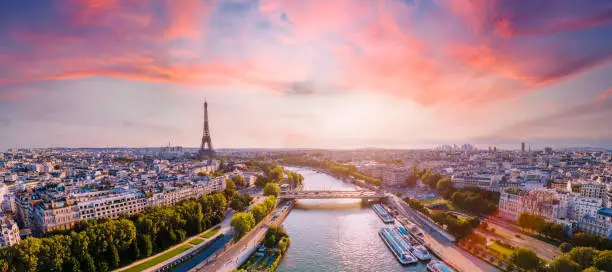 Photo of Paris aerial panorama with river Seine and Eiffel tower, France. Romantic summer holidays vacation destination. Panoramic view above historical Parisian buildings and landmarks with sunset sky