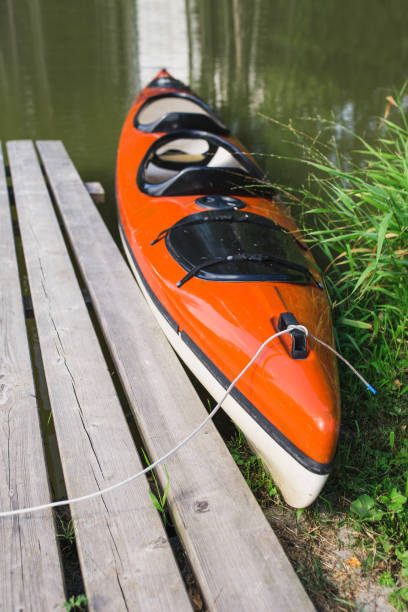 istock Double plastic kayak at the wooden pier on the river 1341937027