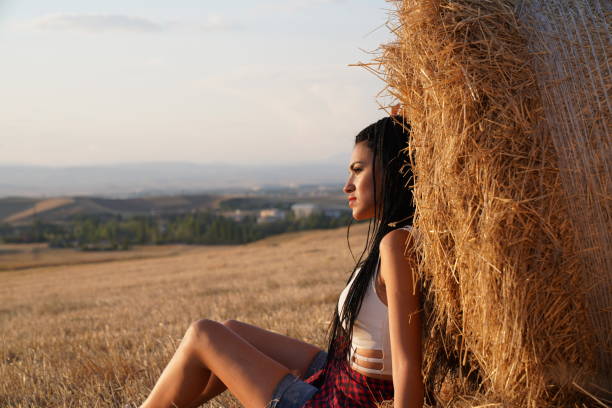 istock Young women and agriculture bale. 1341938580