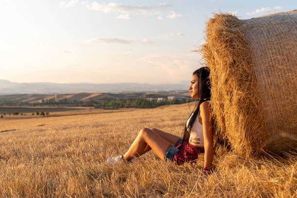 istock Young women and agriculture bale. 1341938585