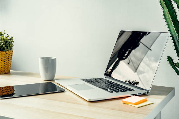 istock Laptop in a light room on working table with office supplies 1341941268