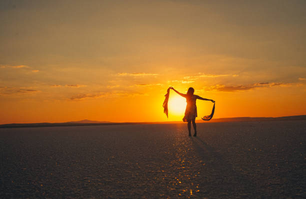 istock woman dancing at sunset 1341942660