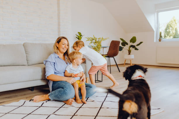 istock Little boys playing with mom and dog 1341943228