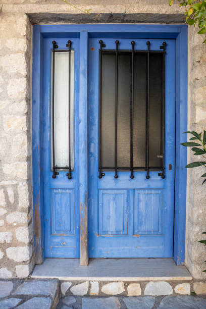 istock Entrance door with blue shutters in stone wall 1341943568