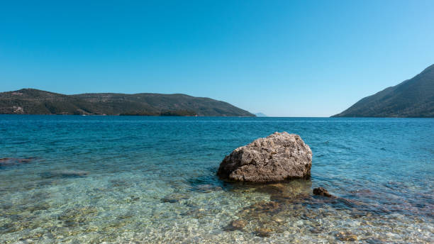 istock Big rock in water on Lefkada island beach, Greece 1341943920