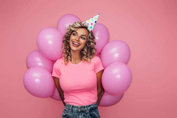 istock Happy beautiful woman with balloons 1341945994