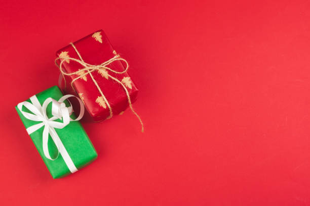 istock Wrapped gift box on a red background, view from above 1341947209