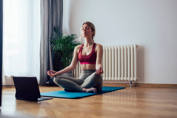 istock Young Woman Practicing Yoga in the Morning 1341947368
