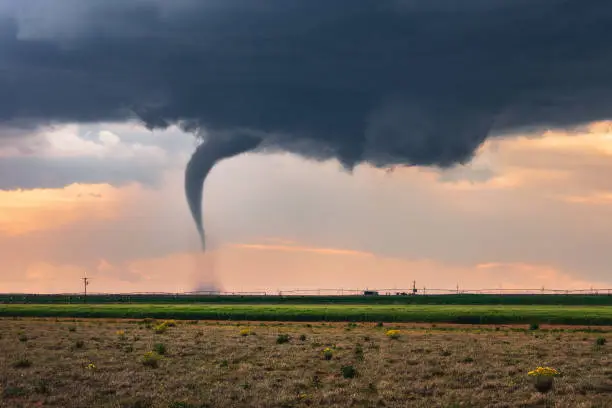 A tornado funnel spins beneath a supercell thunderstorm during a severe weather outbreak in Texas.