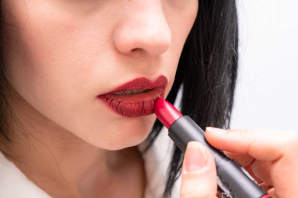 istock business woman applying a red lipstick 1341953204