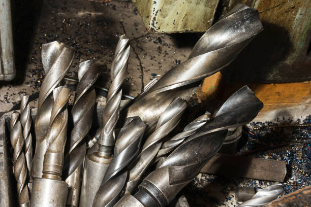 istock large spiral metal drills in a box in the workshop, drilling machine 1341955729