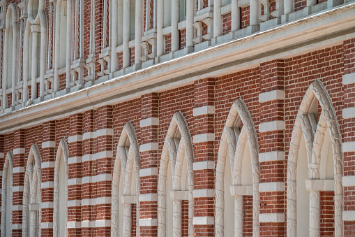 Brick wall of an old 18th century building with large windows. Large windows in an old red brick building. Grand Palace in Tsaritsyno Park, Moscow, Russia