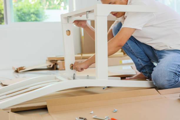 istock Man assembling white chair furniture at home 1341961993