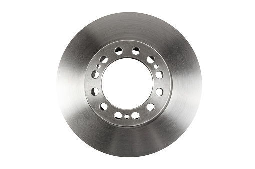 The front brake disc of a passenger car's top view is isolated on white background. A spare part for a passenger car. Part of the braking system of a vehicle. The main element of the disc brake system.