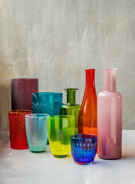 istock Many Different glass jar and glass cups and surface reflections on pink table cloth. 1341963251