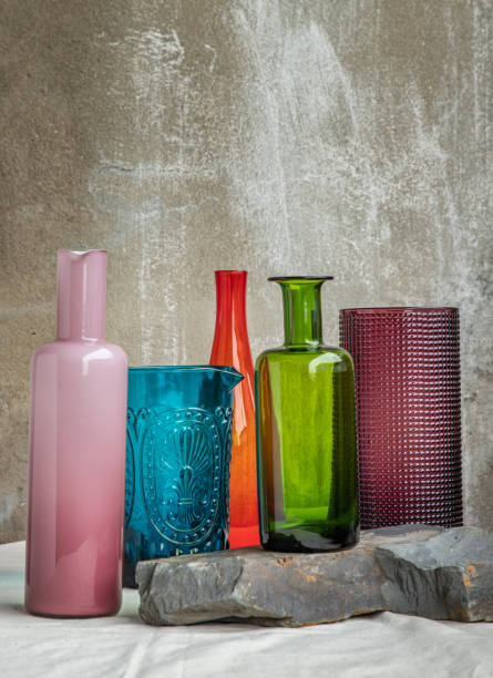 istock Many Different glass jars and surface reflections on pink table cloth. 1341963278