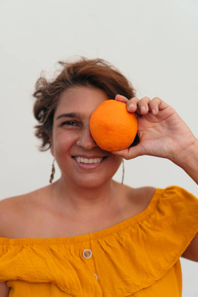 istock woman enjoying the sunny day with orange 1341963625