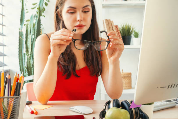 istock Young woman working in office using computer, sitting at desk 1341963875