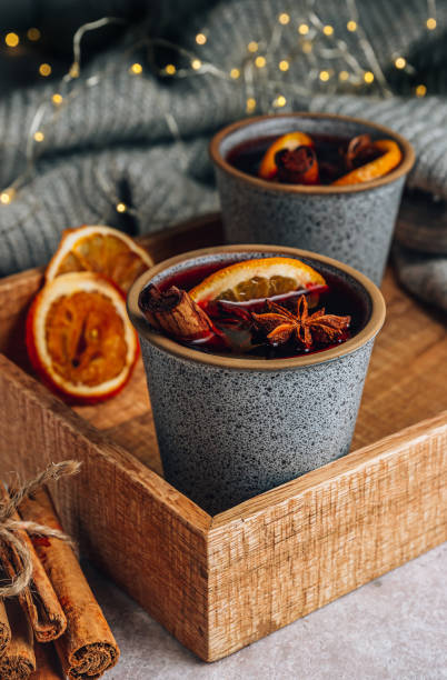 Christmas mulled wine. Winter cozy composition with two cup on wooden tray Christmas mulled wine. Winter cozy composition with two cup on wooden tray. Selective focus mulled wine stock pictures, royalty-free photos & images