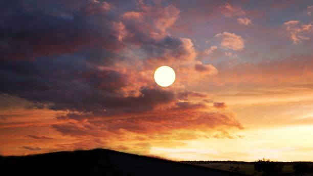 istock Full round sunset with gorgeous clouds in the skies 1341973781