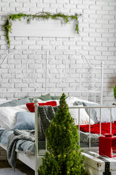 istock Modern light bedroom interior decorated for Christmas 1341974542