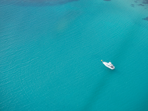 Aerial view of boat anchored on a reef