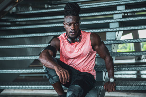 istock Afro young athletic man resting on a staircase 1341975561